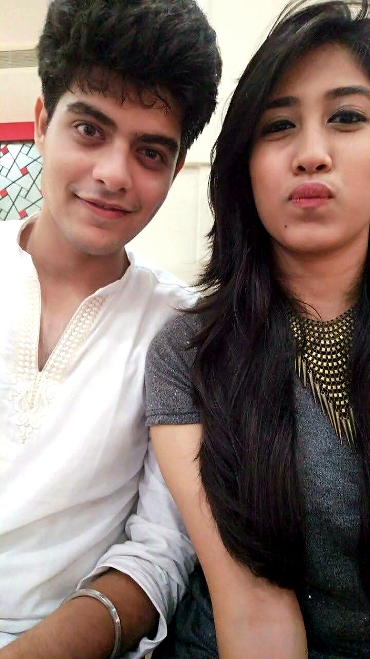 Dipti and Akash sitting side by side, with Akash in a white kurta
