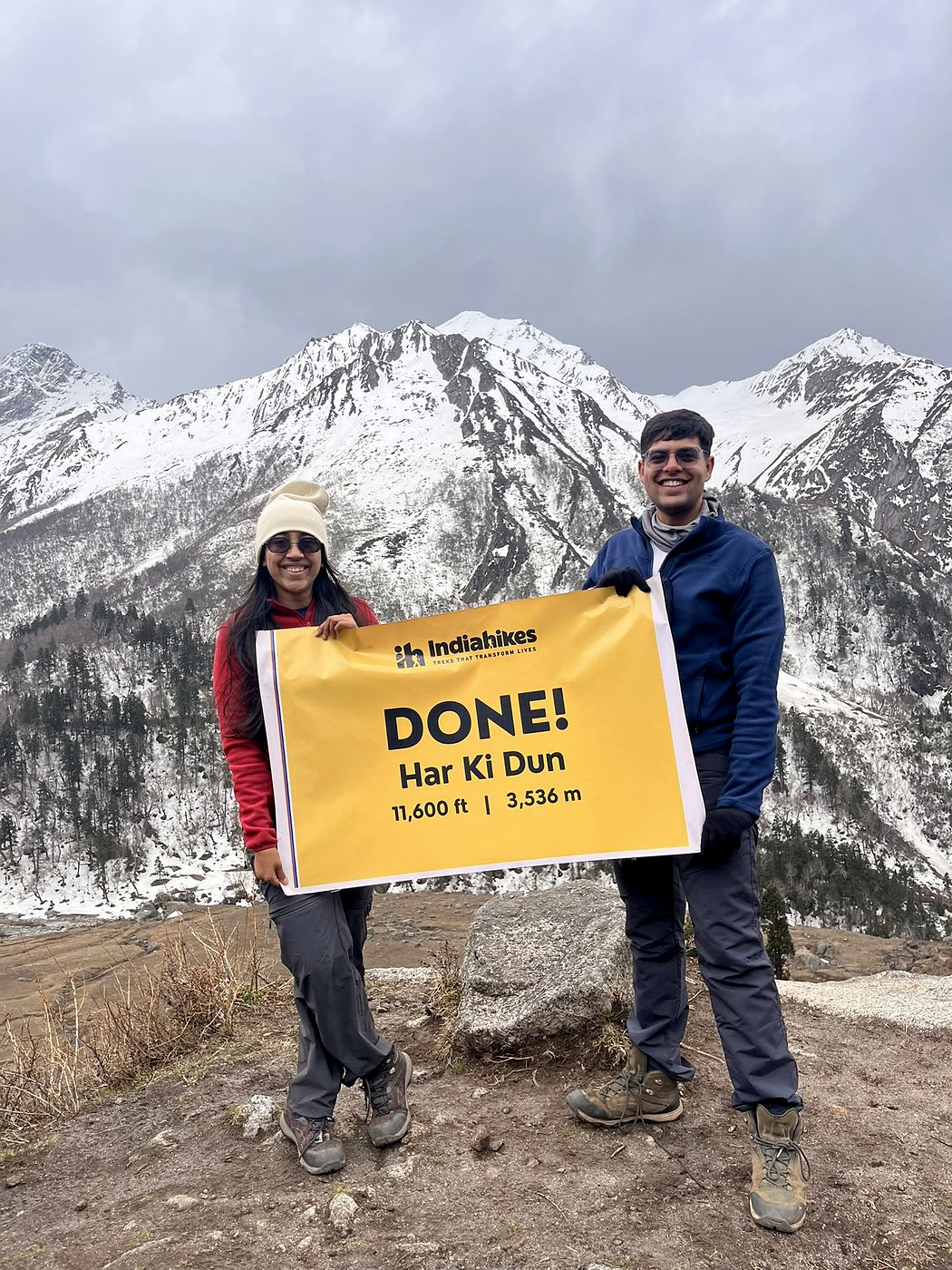 Holding the summit banner at Har Ki Dun, 11,600 feet, snow on the peaks behind